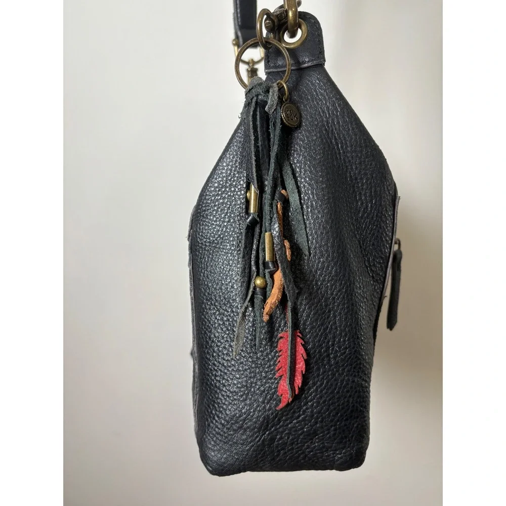 The Sak Alameda Hobo Bag Medium Black Pebbled Leather Feather Fringe Charm
